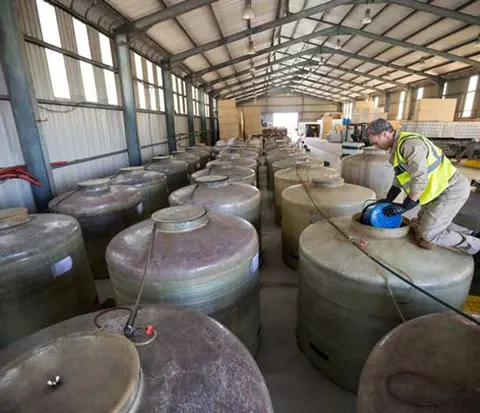 worker-removing-oil-from-tank-web-p